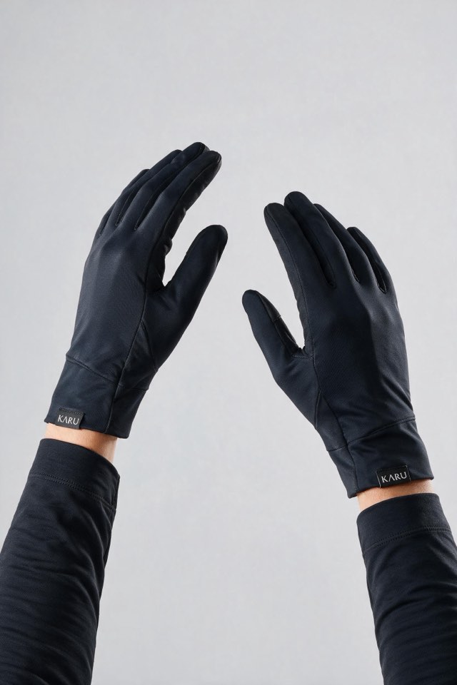 Kärke Gloves in night black, worn by a model, studio product shot on a seamless neutral ground