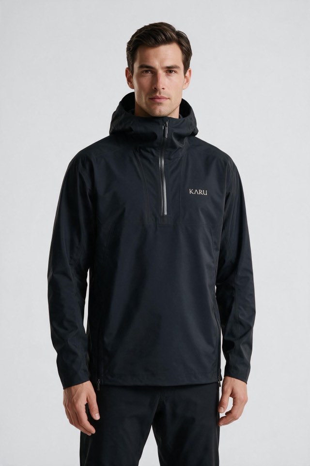 Kårsa Anorak in night black, worn by a model, studio product shot on a seamless neutral ground
