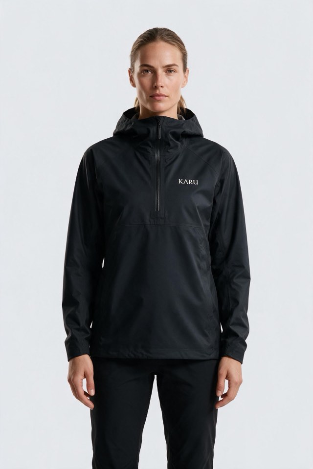 Kårsa Anorak in night black, worn by a model, studio product shot on a seamless neutral ground