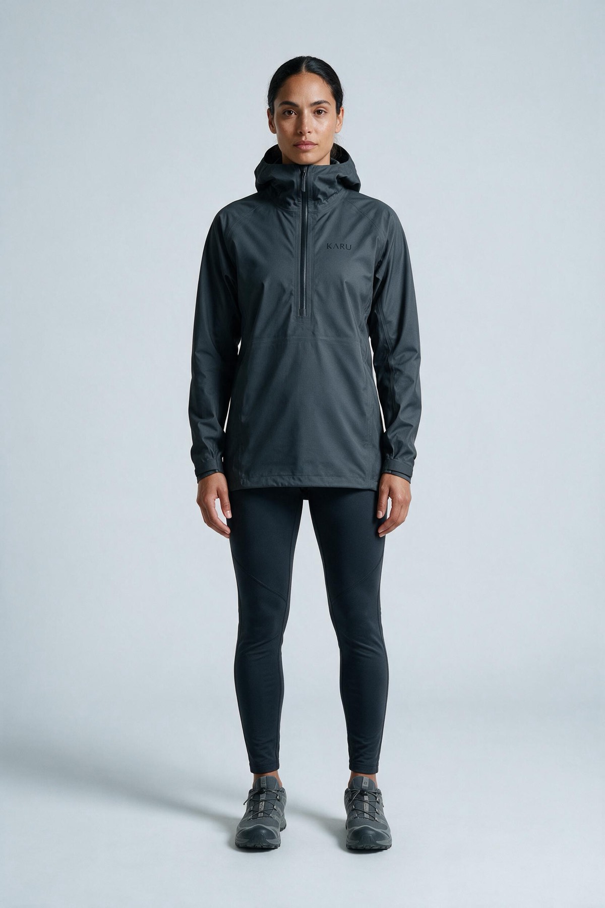 Kårsa Anorak Graphite in dark graphite grey, worn by a model, studio product shot on a seamless neutral ground